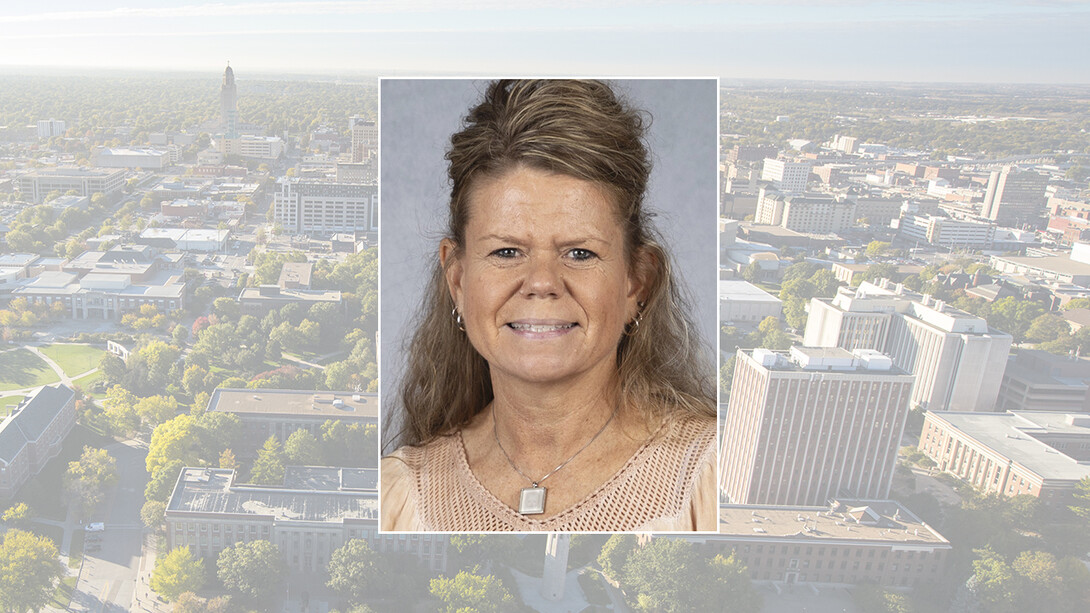 Color portrait of Terri Hogue, math teacher at Falls City Middle School, on a UNL campus background.