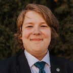 Color portrait of Kendall Bartling, wearing a suit and tie.