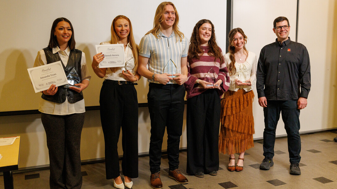 The finalists in the 2026 Philip Perry Photojournalism Challenge — (from left) Amanda Yuan, Hannah Herrera, Brady Cornelius (second place), Alex Gryczanowski (third) and Makayla Maxson (first) — pose with Adam Wagler, interim dean of the College of Journalism and Mass Communications.