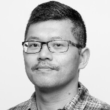 Black-and-white headshot of artist Binh Danh.