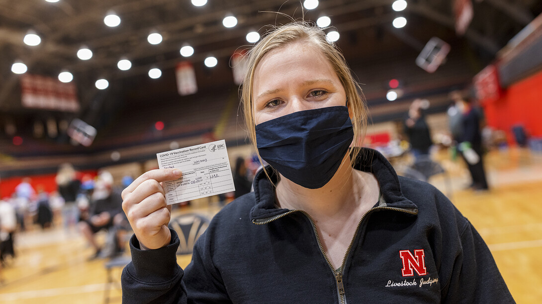 Nebraska's Whitney Steckel displays her vaccine card after getting her first inoculation during an on-campus clinic on April 20.