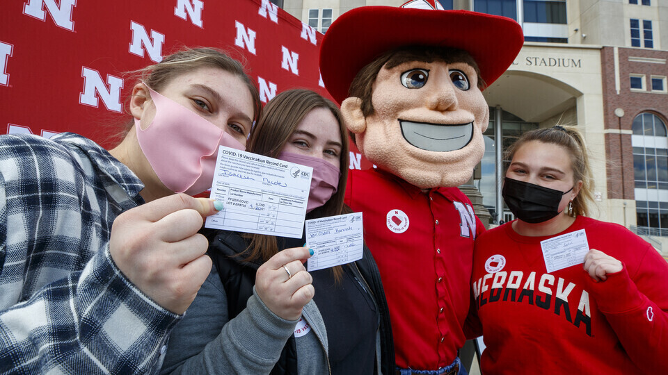 Students took time to pose with Herbie Husker after getting vaccinated in the on-campus Pfizer vaccination clinic in the spring.