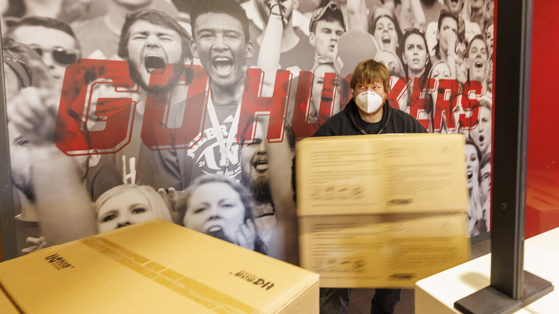 Jason Baird, a material service worker with Facilities Maintenance and Planning-Business Operations, unloads cases of KN95 masks in the Nebraska Union on Feb. 1. A partnership with the State of Nebraska procured 150,000 of the masks for the campus community. Distribution starts Feb. 2.