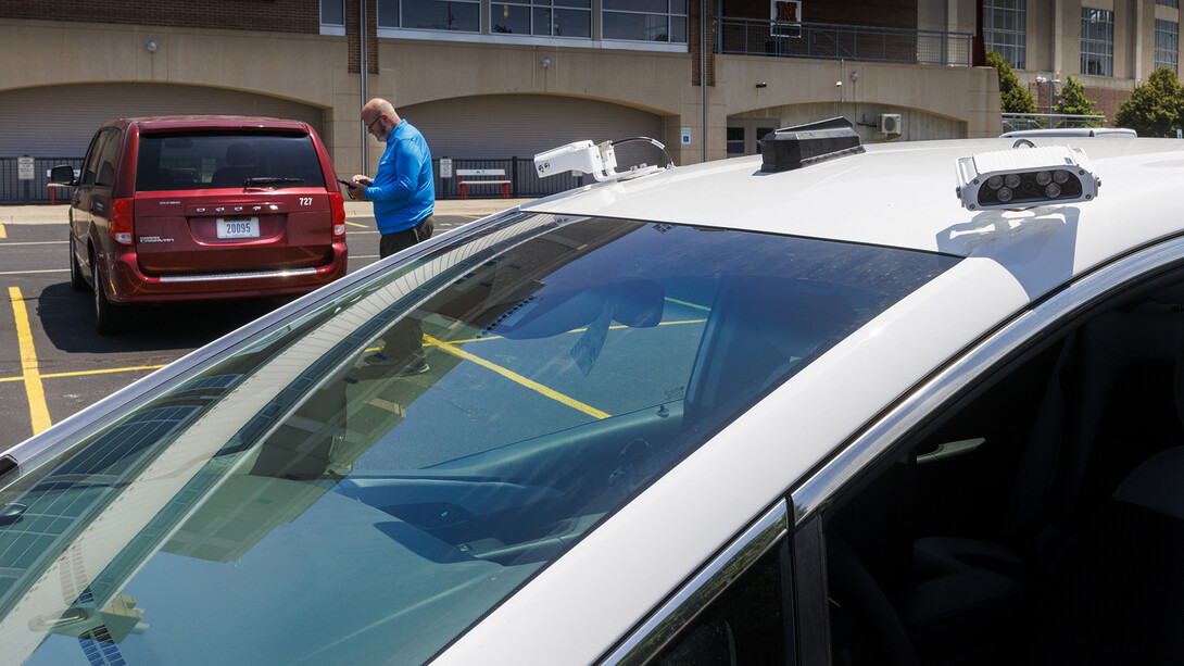 Bill Manning, operations manager for Parking and Transit Services, demonstrates how the new parking enforcement system will work. The update includes scanners that read license plates, identifying which vehicles in campus lots are allowed to park versus those that are parked illegally. The new system goes into place July 1.