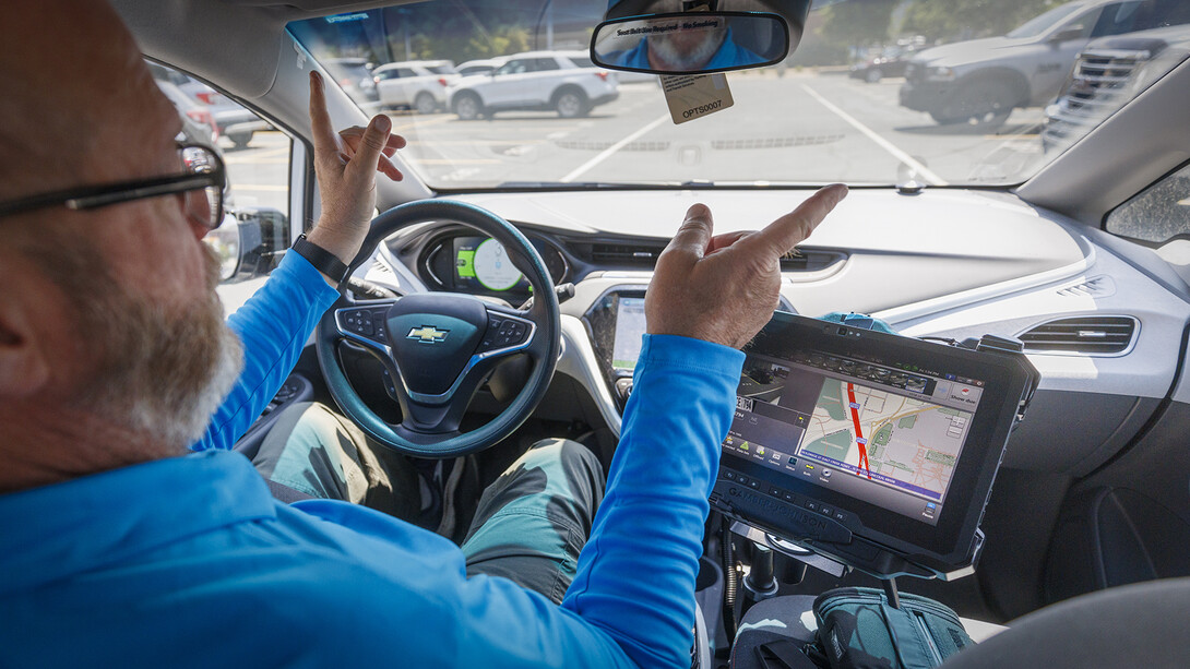 Bill Manning, operations manager for Parking and Transit Services, explains how the scanners work while inside a vehicle that was recently updated to allow for the scanning system.