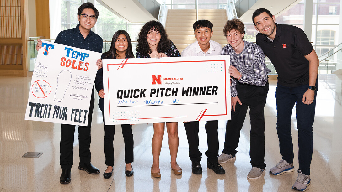 Dream Big Academy award winners holding a giant check after winning a pitch competition.