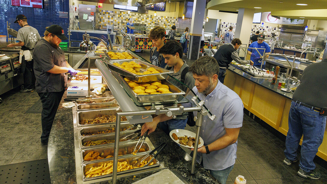 Members of the university community filling plates at the Harper Dining Hall.