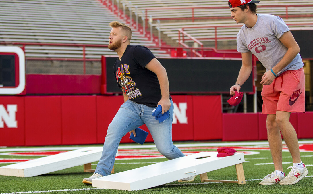 Nik Ostrovski throws during the Homecoming Cornhole Tournament in Memorial Stadium Sept. 29.