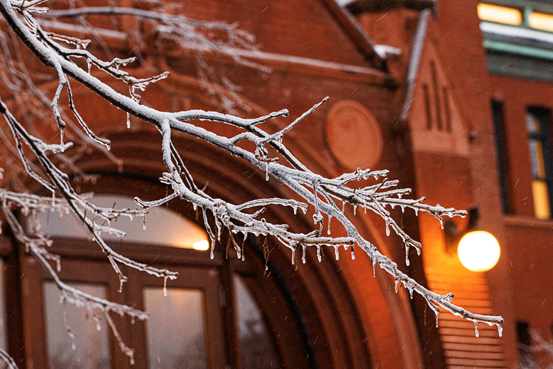 Ice and snow cover campus and are back lighted by the lights on Architecture Hall. 