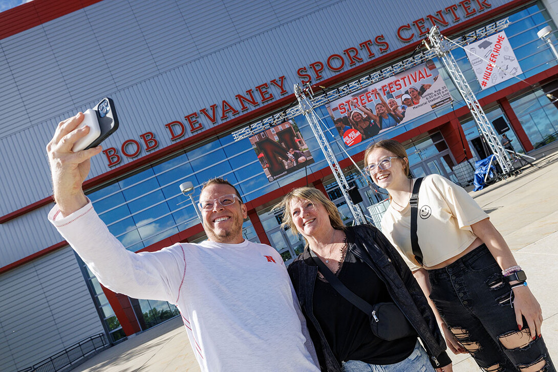 Marissa Brewer of Omaha, right, poses for a selfie with her mom and dad, John and Michelle, as they enter Devaney Sports Center to start the move in process.