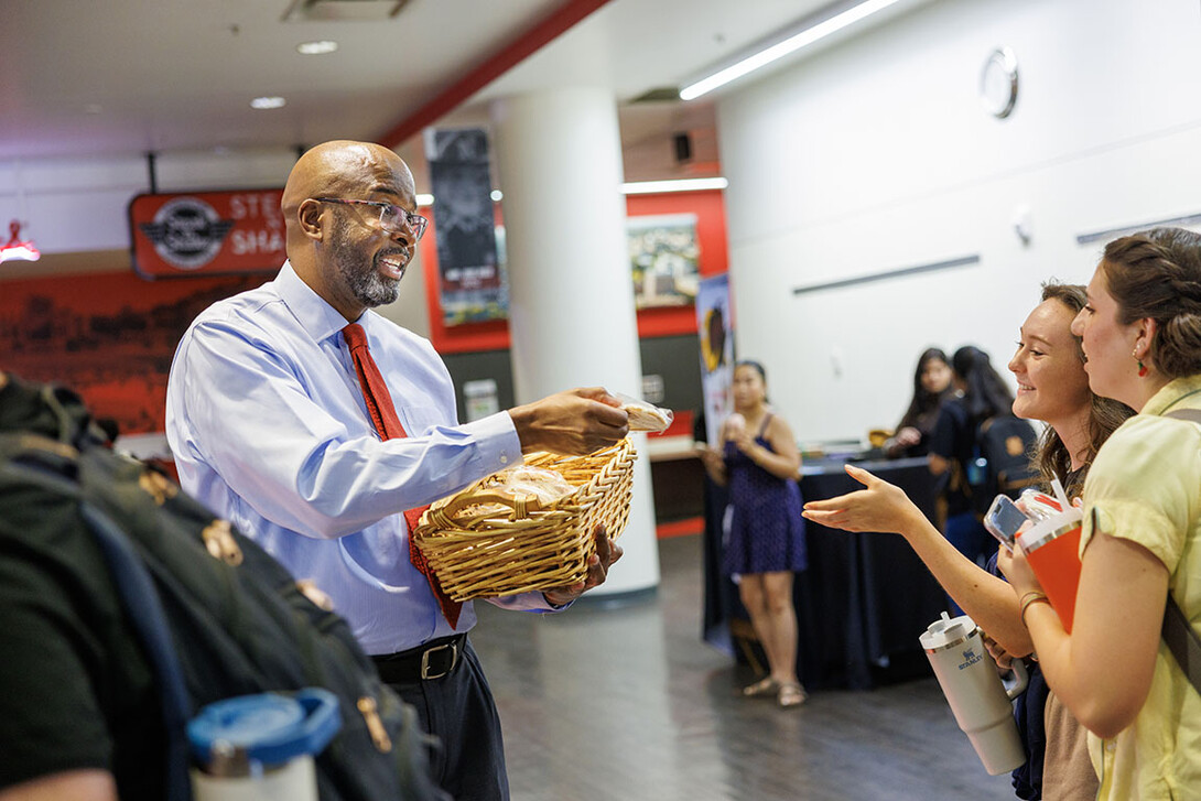 Chancellor Rodney Bennett passes out cookies at Nebraska Union Monday morning.