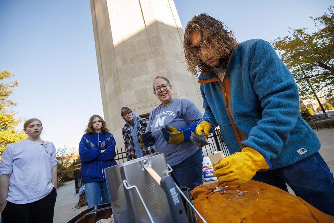 Dylan Kapustka, sophomore in history, makes a pour into the mold of a pilgrims’ badge of Thomas Becket, former Lord High Chancellor of Great Britain, as Carolyn Twomey watches.