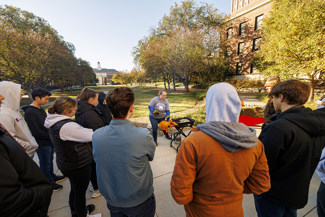 Carolyn Twomey’s HIST211 History of the Middle Ages class watches as Twomey demonstrates how to cast medieval pilgrims’ badges Thursday morning.