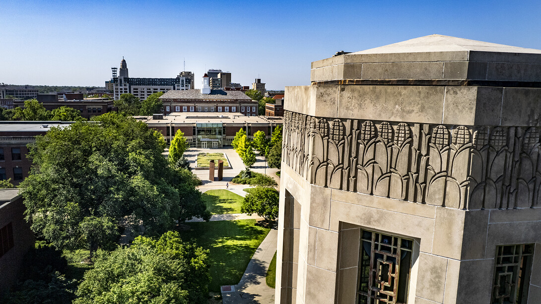 Aerial view of campus that includes the top of Mueller Tower in the foreground and Love Library in the background.