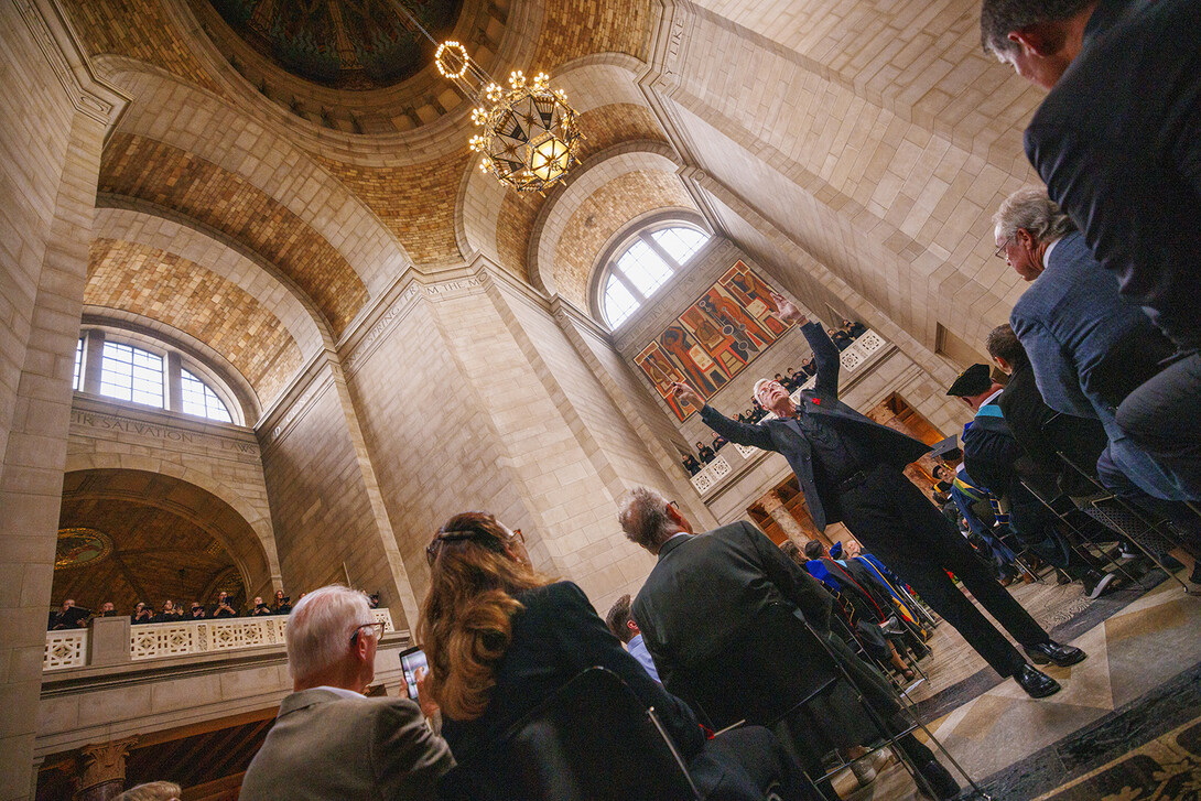 Peter Eklund, professor of music, conducts the University Singers during the Sept. 5 investiture. The choir sang from all four balconies overlooking the rotunda in the Nebraska State Capitol.