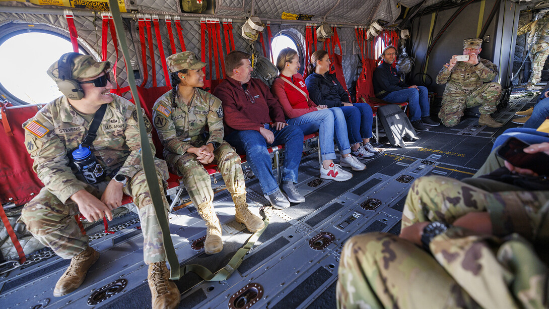 Lt. Col. Tom Slykhuis takes a photo of the cadets (from left) Colten Stevens and Alyssa Batista, and UNL’s Justin Chase Brown, Erin Burnette, and Becka Neary-DeLaPorte in the Chinook helicopter before takeoff at Nebraska Innovation Campus.