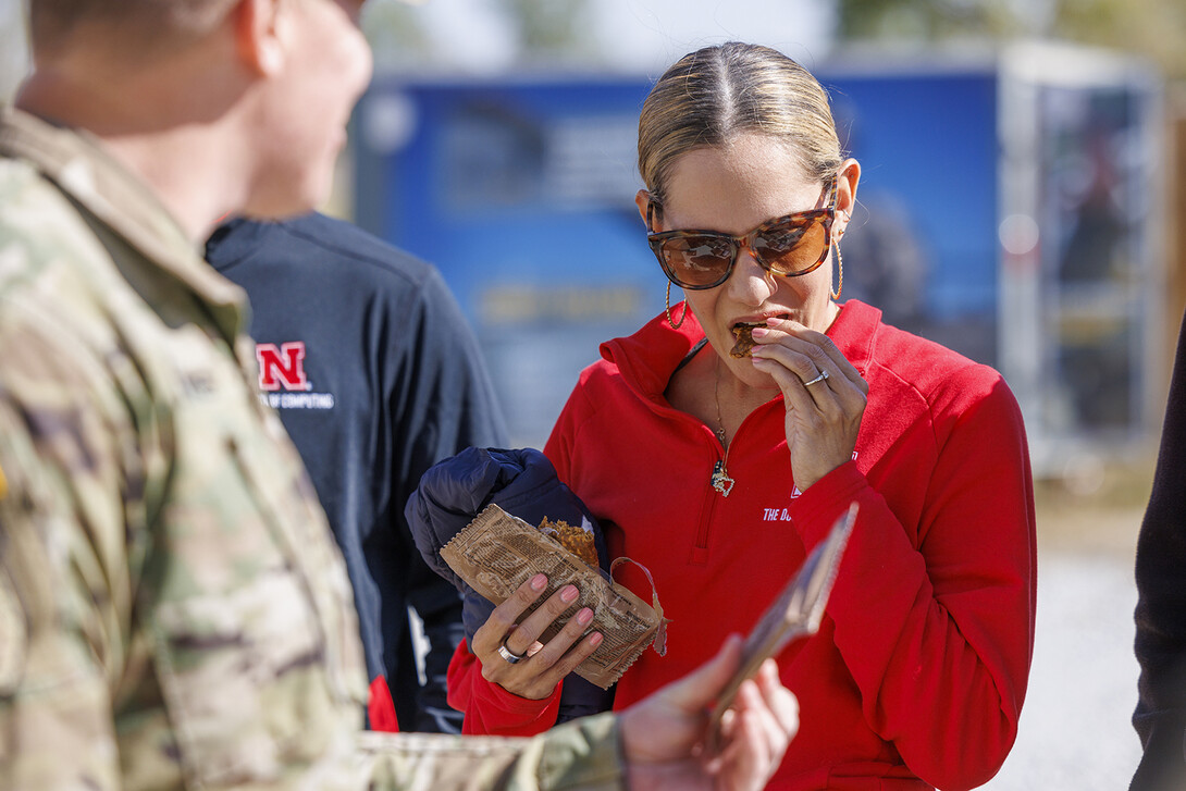 Emmeline Watson, assistant professor of practice in the Durham School of Architectural Engineering and Construction, samples an apple cinnamon nutrition bar from a meal-read-to-eat. Faculty and staff were able to try many of the MRE options during the event.