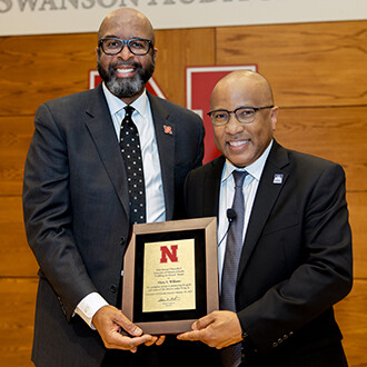 Chancellor Rodney D. Bennett (left) presents the Chancellor's Fulfilling the Dream award to Harry L. Williams, president and CEO of the Thurgood Marshall College Fund, on Jan. 28 in the Nebraska Union's Swanson Auditorium.