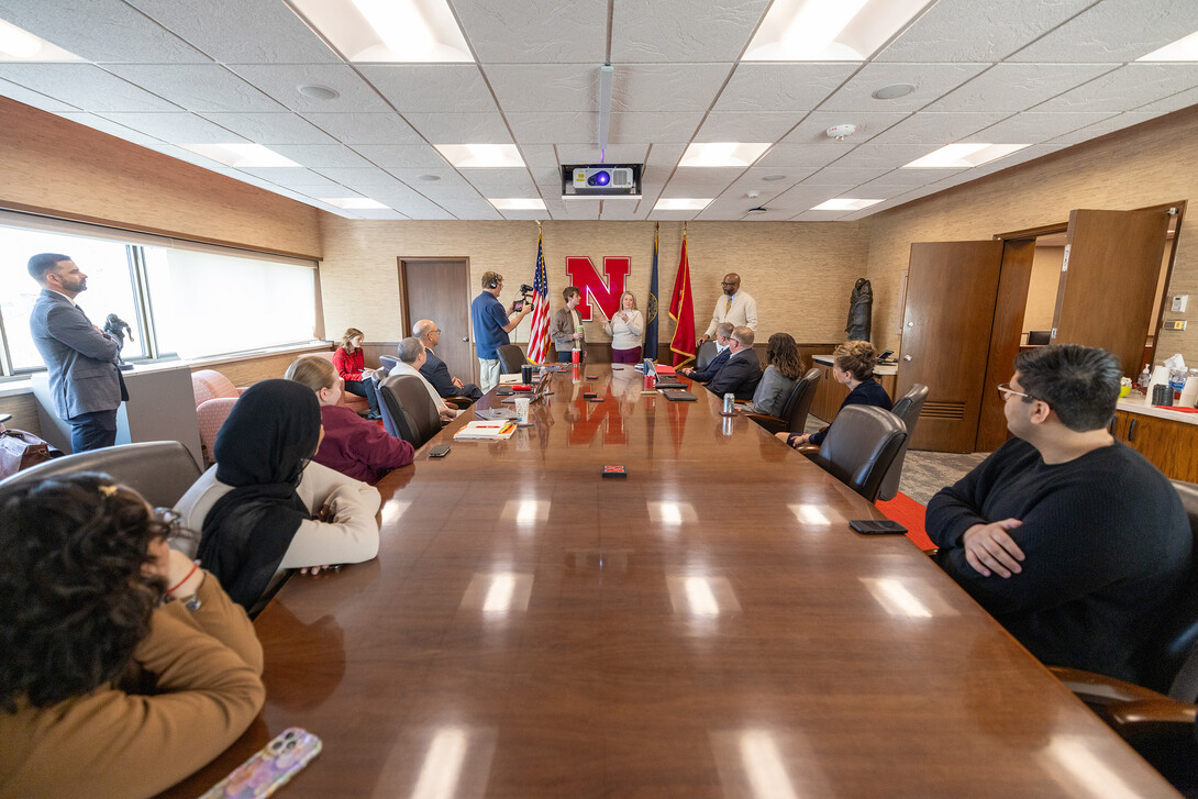 A full conference room in the Chancellor's Office listens as Jessica Herrmann speaks about nominating Luke McDermott for the Truman Scholarship.