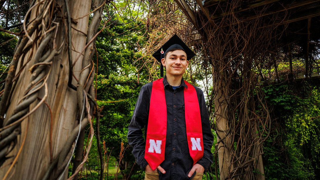 Caden Simon, a double major in environmental science plus regional and community forestry, stands under the vine arbor in the University of Nebraska–Lincoln's Maxwell Arboretum. He is the only Husker graduating this semester with that major combination.