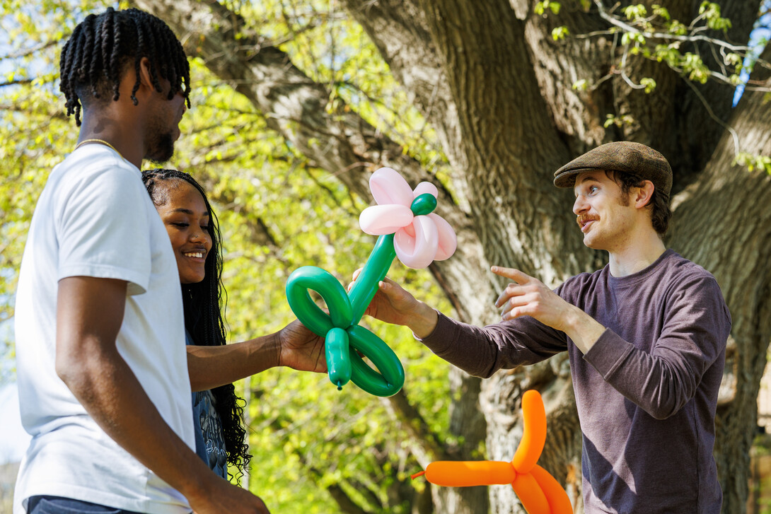 Freshman Isaiah Holmes and Mariyah Coleman receive a balloon flower made from local balloon artist.