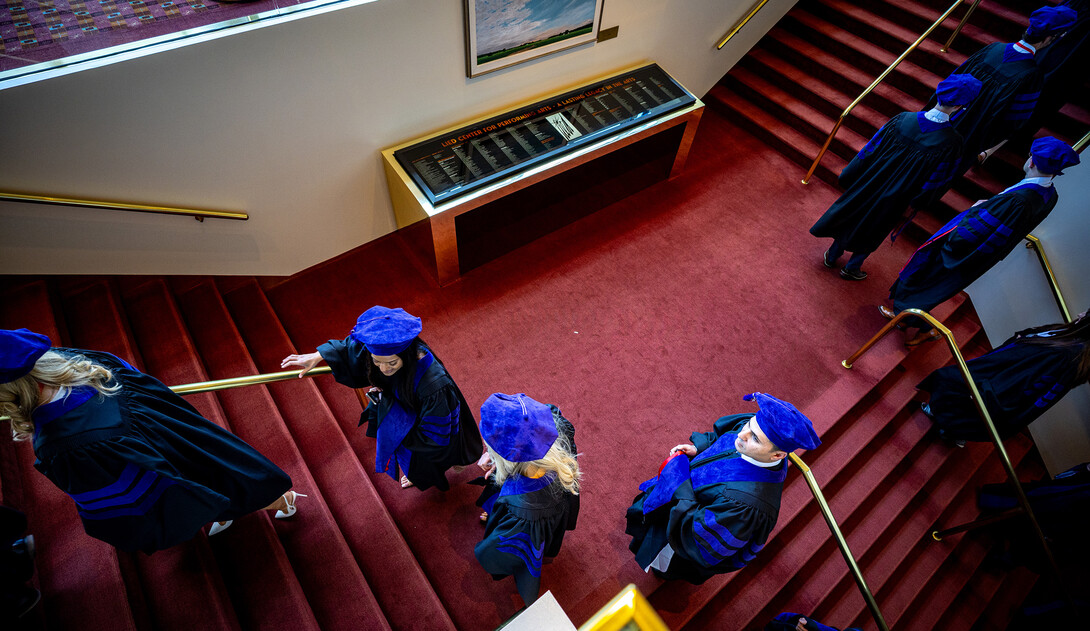 College of Law graduates climb the red staircase in the Lied Center for Performing Arts prior to ceremonies May 3.