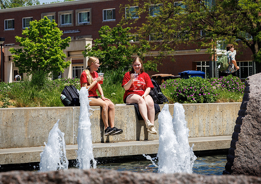 Senior, Ellie Kress, and Sophomore, Ellie Hoegemeyer, sit by the Brohill Fountain drinking lemonade during the “FriYay Unwind Fest” at the City Campus Union.