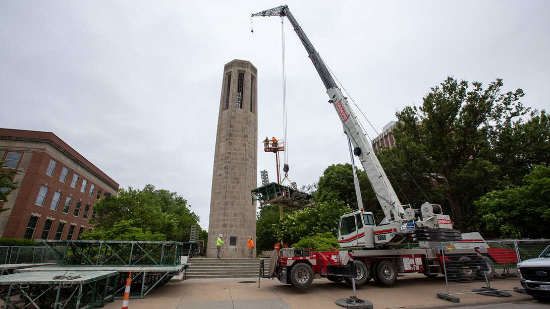 A crew from Kehm Contractors begins to move scaffolding into place around Mueller Tower while an assessment of stones is being completed.