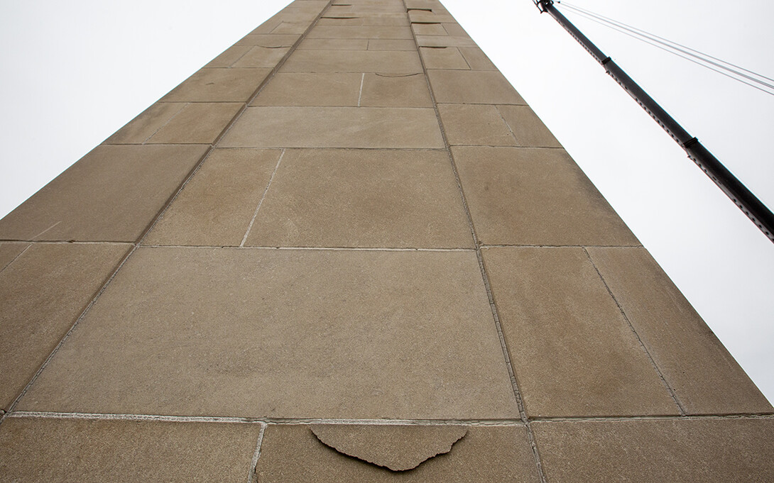 Close up of a cracked Mueller Tower stone. Weather-related damage is being repaired on the university's iconic bell tower.