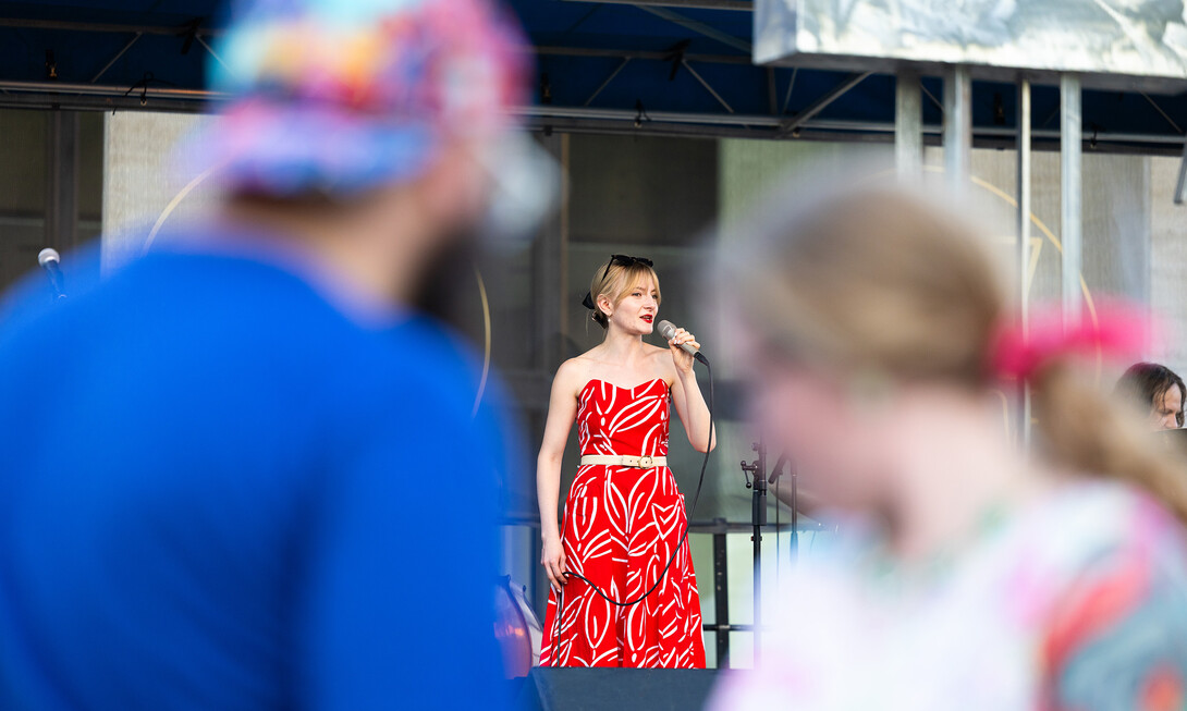 Caity Gyorgy is visible between two dancers as she sings a faster-paced swing tune during Jazz in June on Tuesday, June 10.