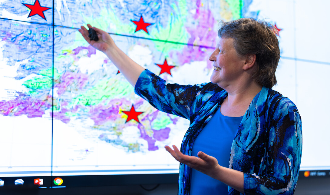 Irina Filina, associate professor of earth and atmospheric sciences, gestures to a graphic of Iceland showing the locations of several volcanoes she wants to visit with students on an upcoming trip.