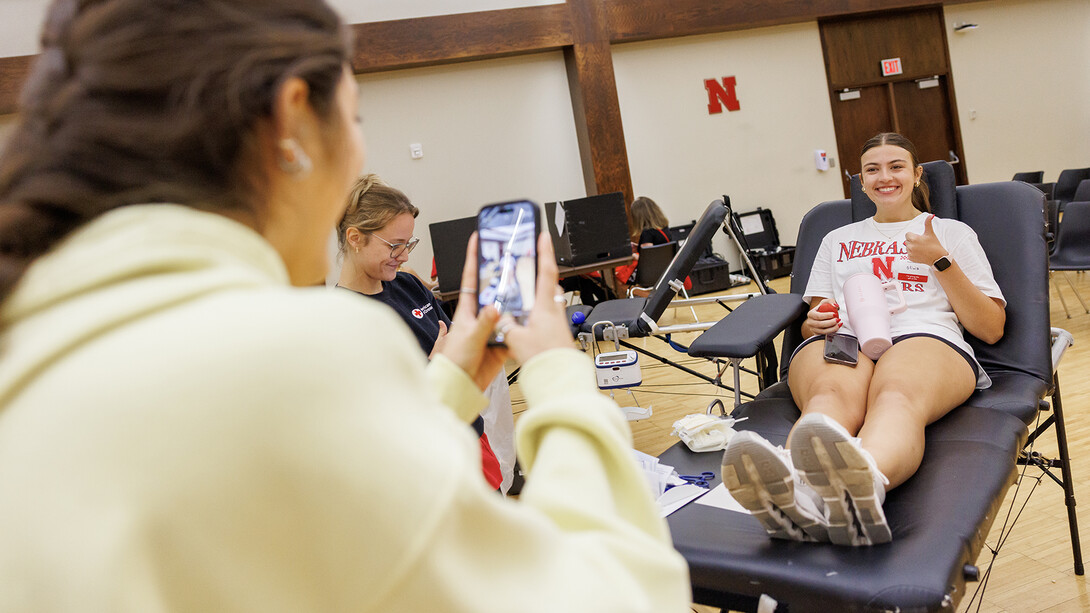 Olivia Burgess, right, sophomore nutritional science and dietetics major, smiles for a photo before giving blood during the 2025 Homecoming Blood Drive inside the Nebraska Union, Centennial Room. Sept. 29, 2025.