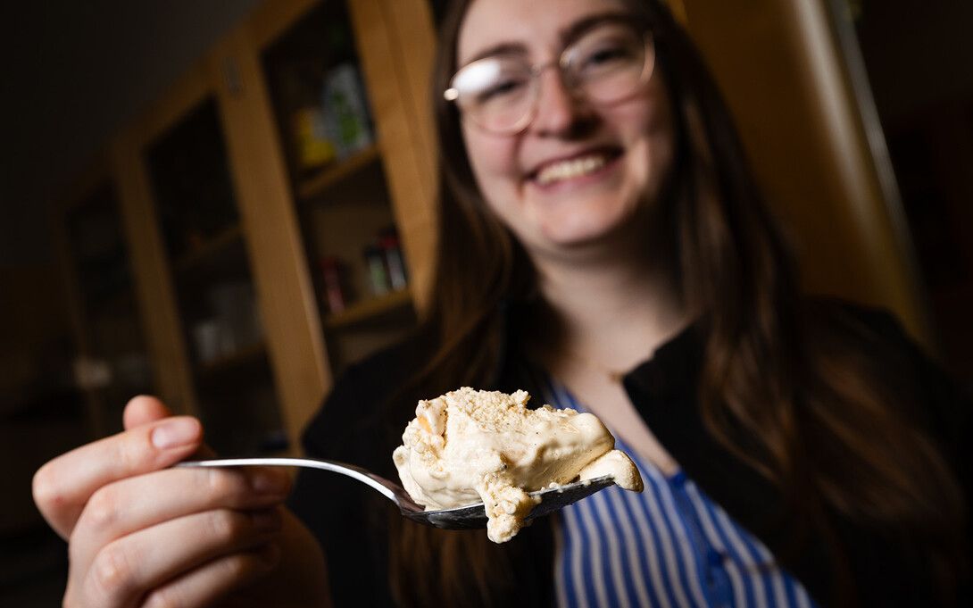 April Johnson, a University of Nebraska–Lincoln graduate and product development project manager, samples Runza-inspired ice cream during testing at the university’s Food Processing Center.
