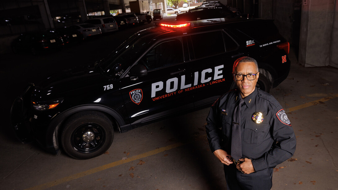 Hassan Ramzah standing in front of a police cruiser.