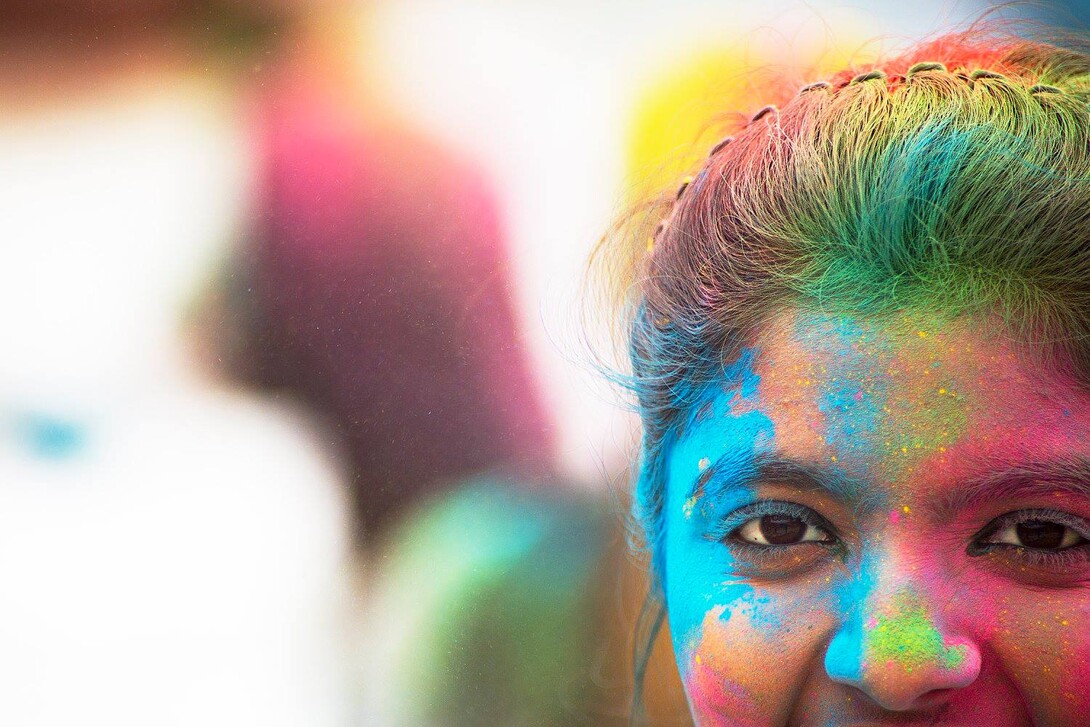 A Nebraska student stands covered by colored powder following the Holi celebration on April 15. The celebration, which is a tradition in India, used colored powder made from food-grade, biodegradable products with FDA approved dyes.