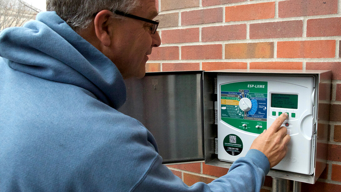 UNL's Fred Thorne tests a new irrigation system. The system can be controlled on site or via a specialized computer program.