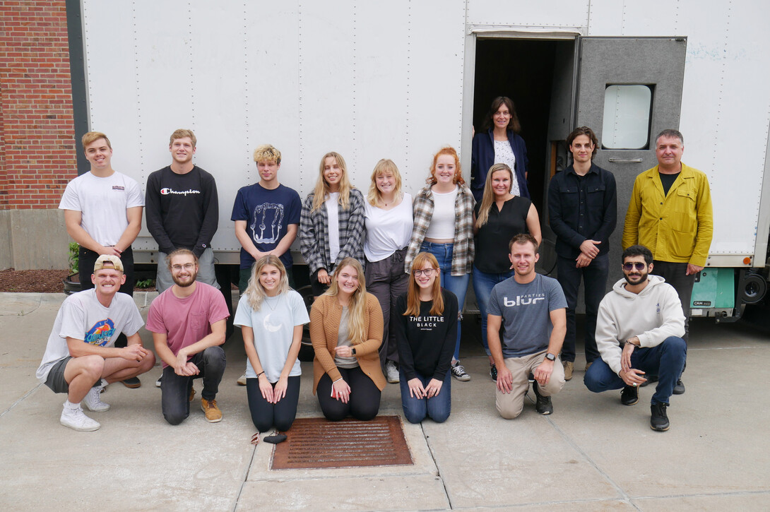 FACT studio students pose in front of their Omaha Mobile Stage