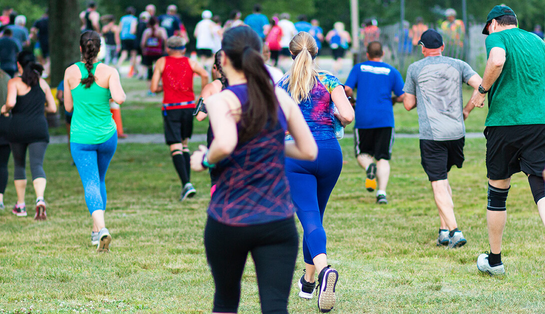 Runners begin a 5K on grass