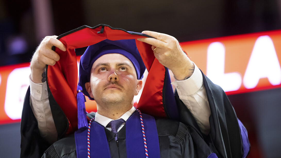 Grant Jones receives his hood at the College of Law commencement on May 3. He will be commissioned into the Air Force on May 19 and will serve in the JAG Corps.