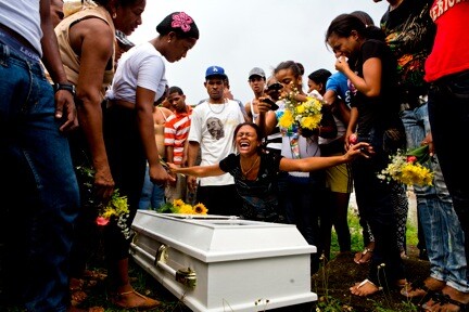 Friends and family mourn the loss of Aneuris Polanco Foxan at Cristo Rey Cemetery. In order to bury Foxan the family had to exhume Smiley Danni Foxan. "We don't have the space and money for another niche," said Hector Williams Foxan.