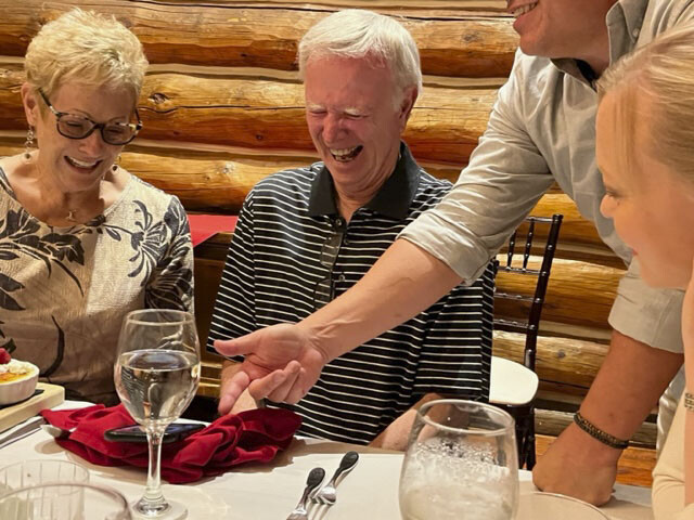 Bill Seiler laughs with coworkers during his retirement party
