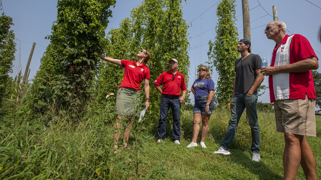 Katherine Kreuser (left) talks about growing hops during a tour of the hop yard on Nebraska's East Campus. Kreuser is the hop program coordinator for the university.