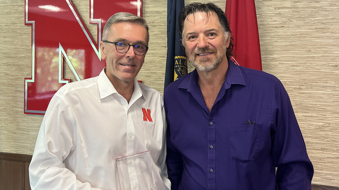 Chancellor Ronnie Green accepts the University Operations Partner of the Year honor from Jim Jackson on June 27.