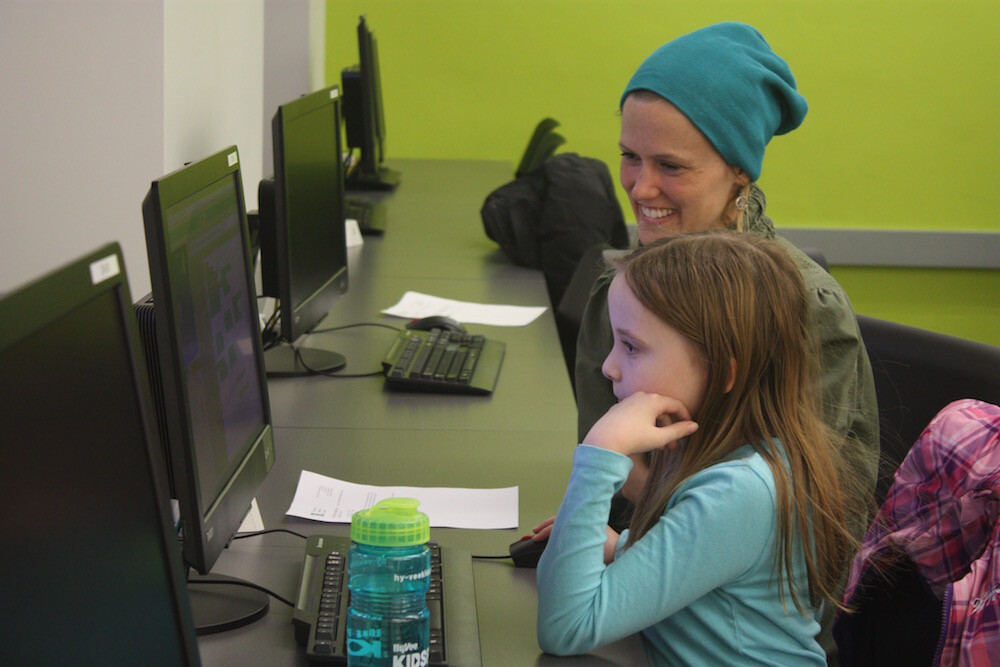 Mentor Gretchen Larsen helps an LPS middle schooler, Brynn, develop her coding skills at the first CADDY workshop.