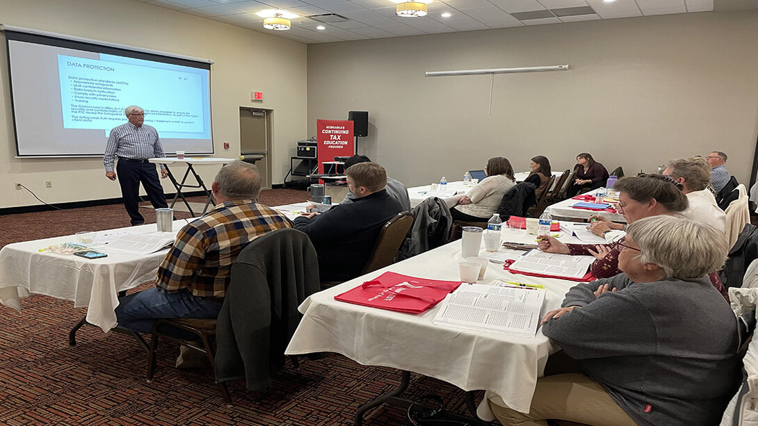 Tax preparers gather for a presentation from the UNL tax institute.