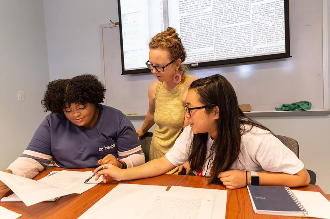 Katrina Jagodinsky, Rosowski associate professor of history, works with undergraduate researchers Kasha Appleton and Natalie Lucas.