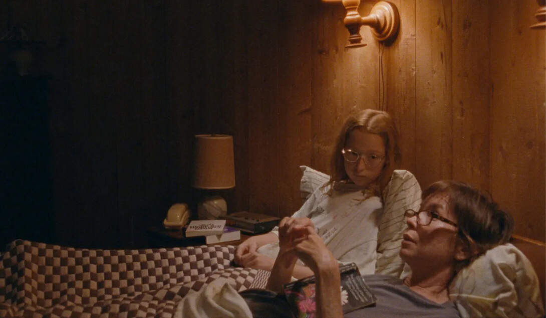 Image of a mom and daughter in bed from the movie "Janet Planet."