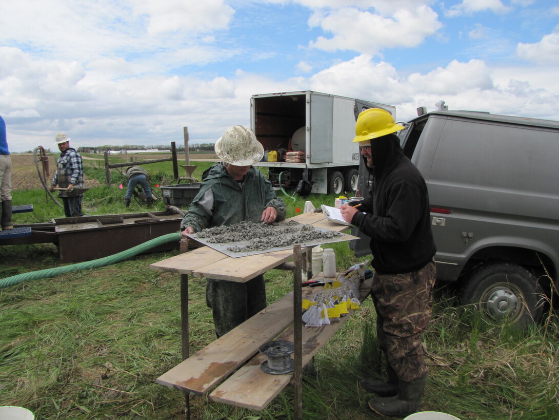 Sue Lackey, left, describes sediment samples to write on the field log and bag for further examination.
