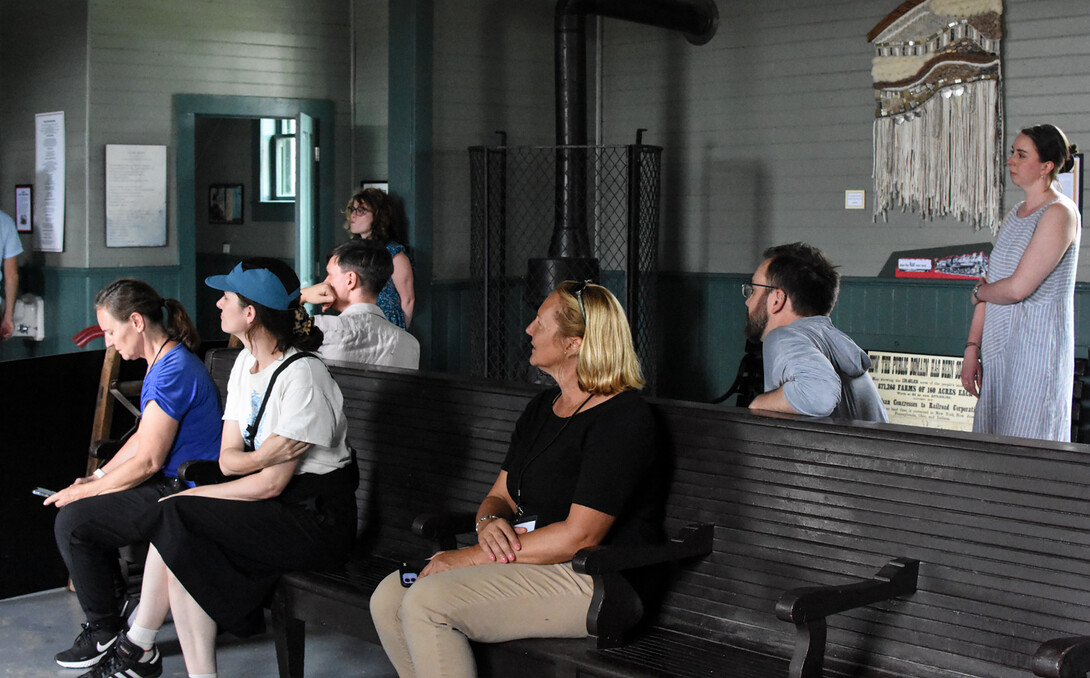 Participants of the NEH Institute experience the Burlington Depot in Red Cloud during a session on railroads in Cather's fiction, led by Mark Van Wienen.