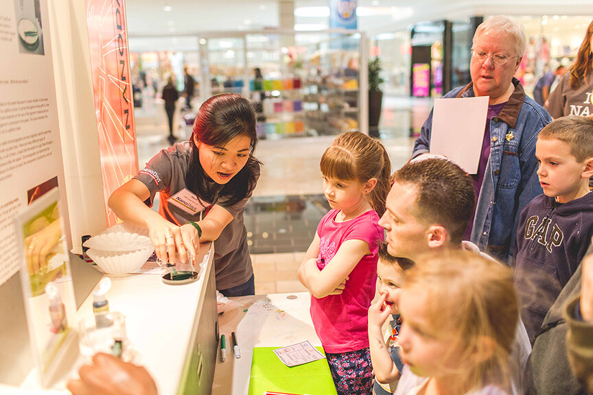 UNL student explains nanoscience to youth at 2014 NanoDays in Lincoln's Gateway Mall.